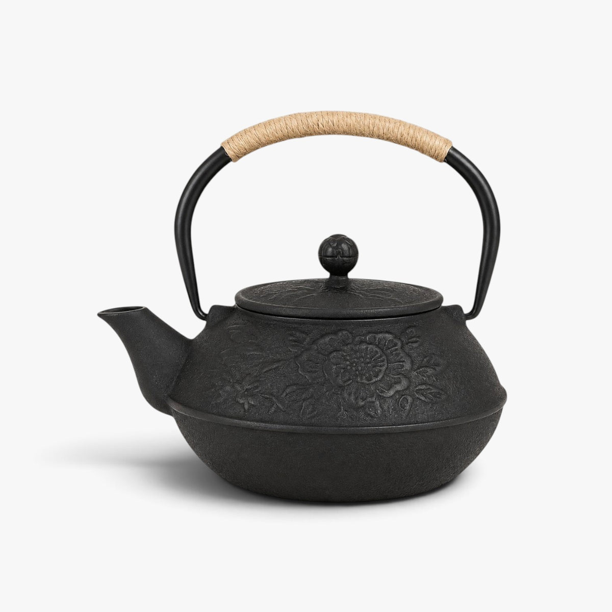Roselva black cast iron tetsubin teapot with intricate floral relief engravings and a rope-wrapped handle.