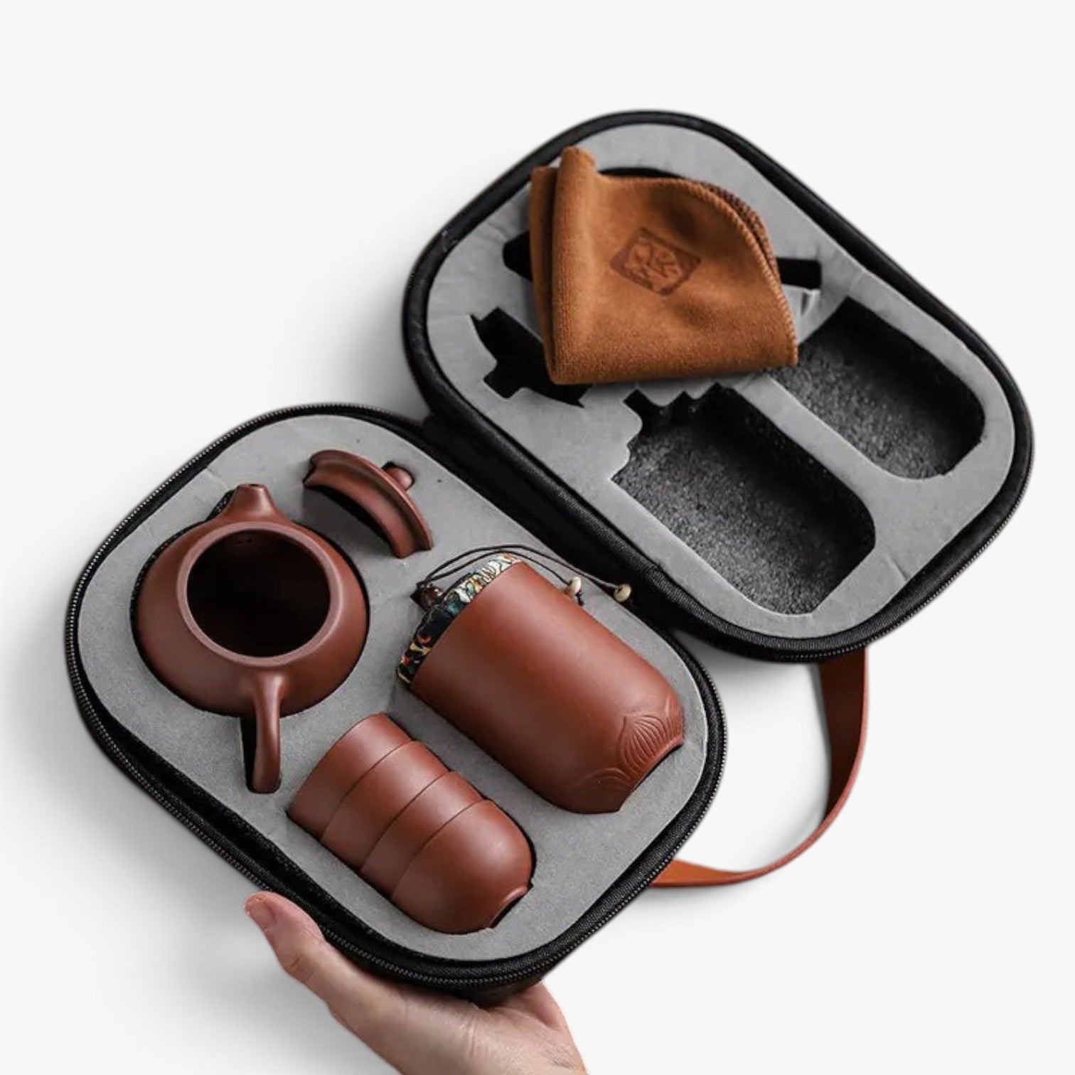 Roselva traditional travel tea set with brown ceramic teapot, cups, and storage jar in a protective travel case.