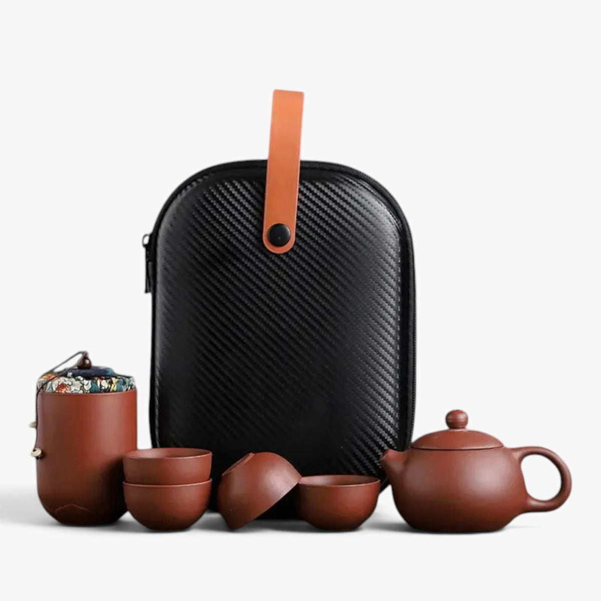 Roselva traditional travel tea set with brown ceramic teapot, four cups, storage jar, and black protective case.
