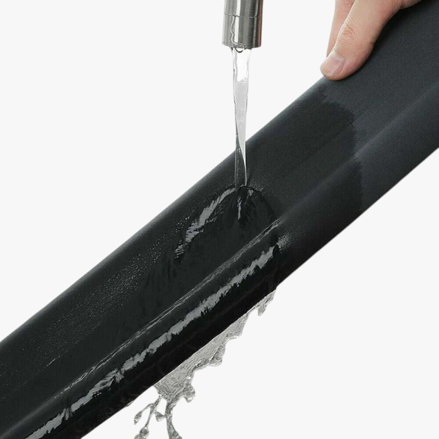 Roselva black foam door weather stripping being tested for water resistance under a running faucet